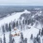 Image shows aerial view of snowy surroundings of the Ylikiiminki church