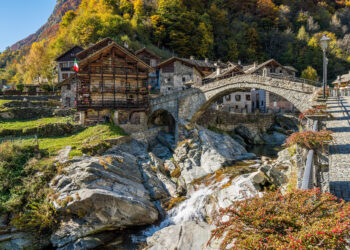 Beautiful bridge in Rassa, Italy, during autumn